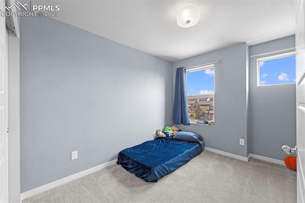 Image 21 of 30: Carpeted bedroom featuring baseboards