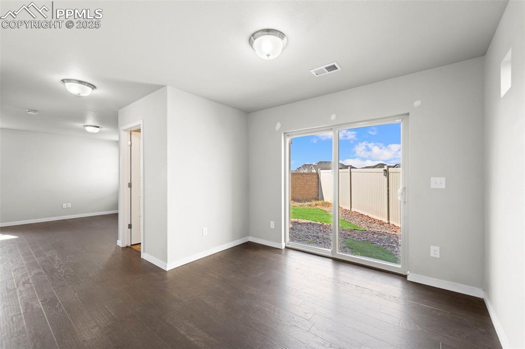 Image 28 of 30: Empty room featuring dark wood finished floors