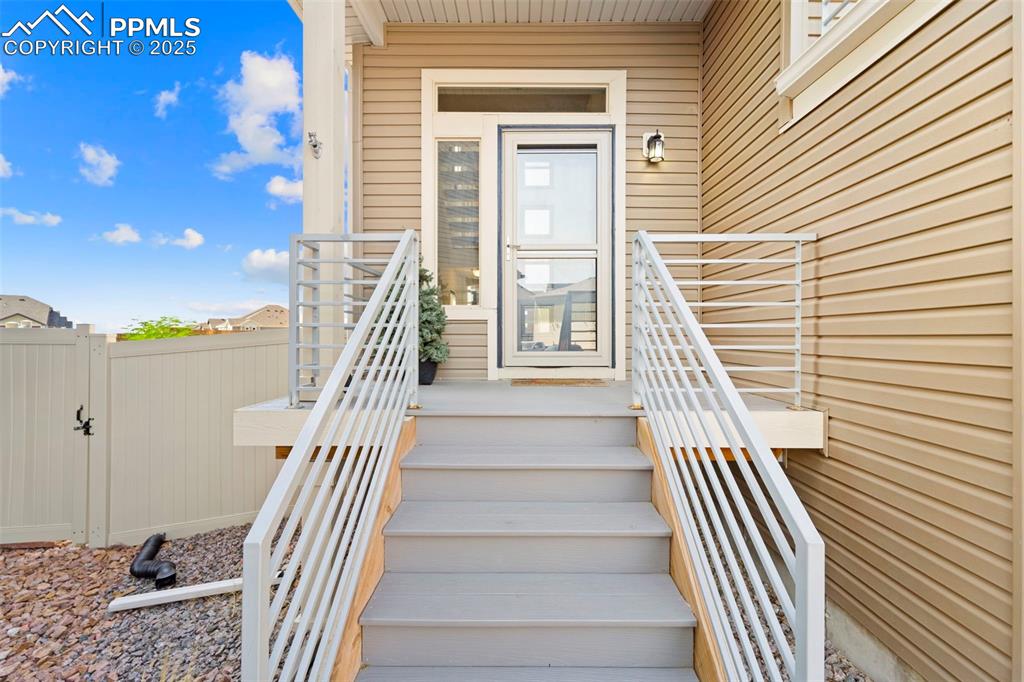 Image 4 of 30: View of exterior entry with a gate