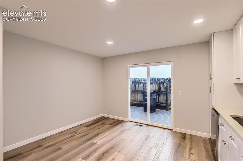 Image 12 of 32: Open concept living space featuring wood-finish flooring, recessed lighting