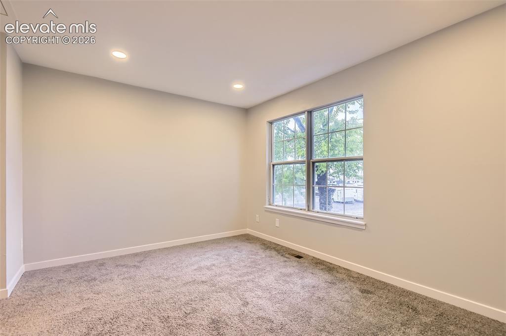 Image 18 of 32: Room featuring recessed lighting, a double-hung window with grid pattern, n