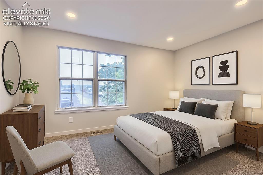 Image 28 of 32: Bedroom featuring neutral wall tones, recessed lighting, a large window, an