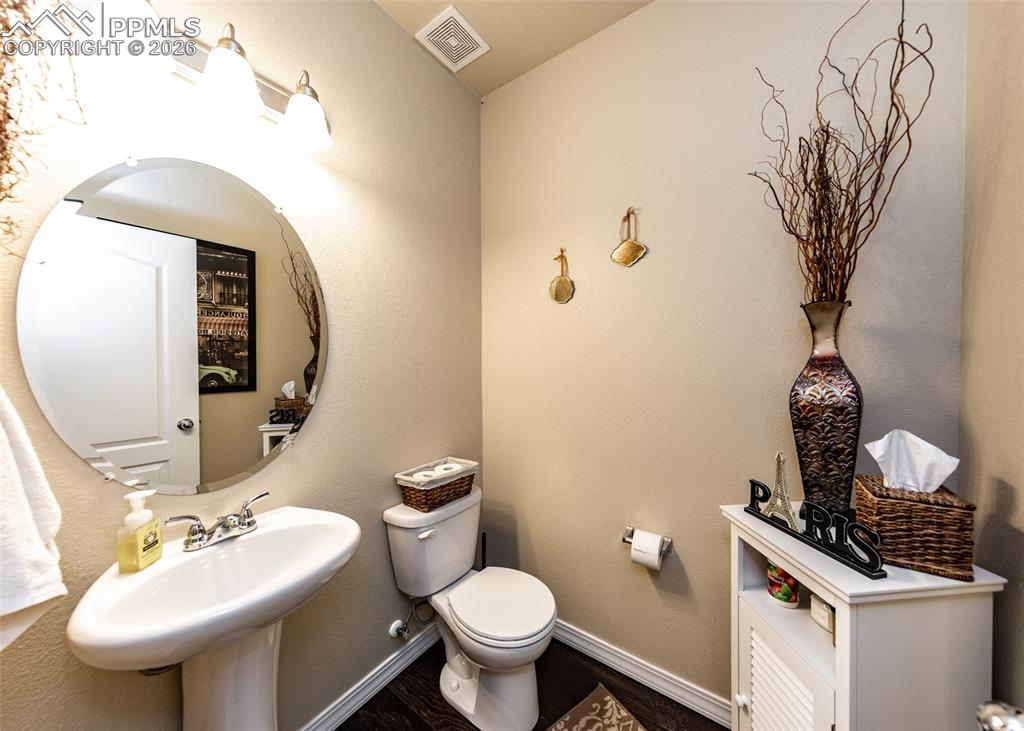 Image 17 of 32: Bathroom featuring a textured wall and wood finished floors