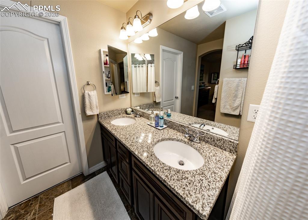 Image 21 of 32: Full bathroom featuring double vanity and baseboards