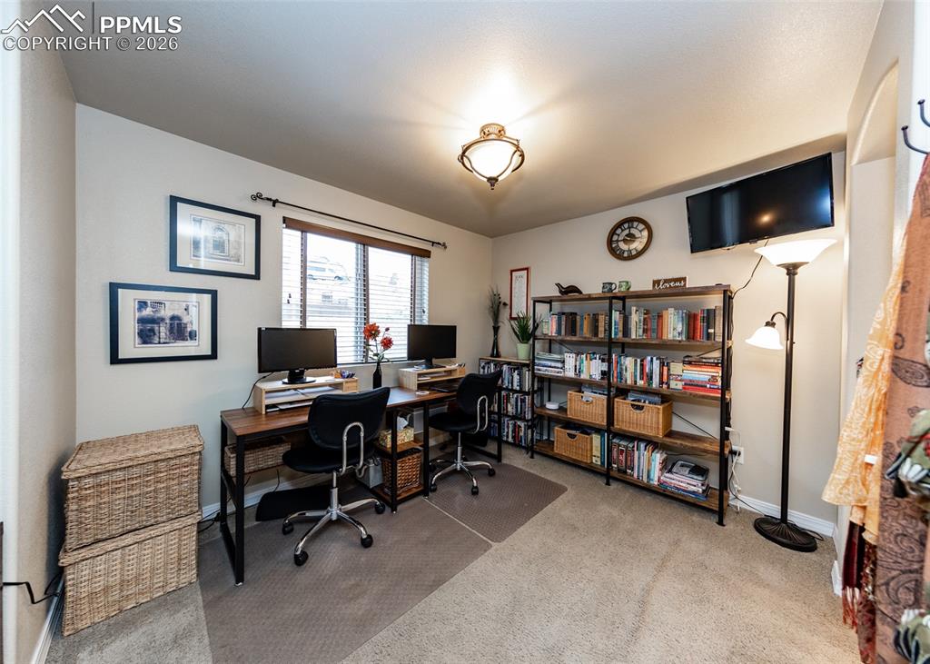 Image 26 of 32: Office space with light carpet and baseboards