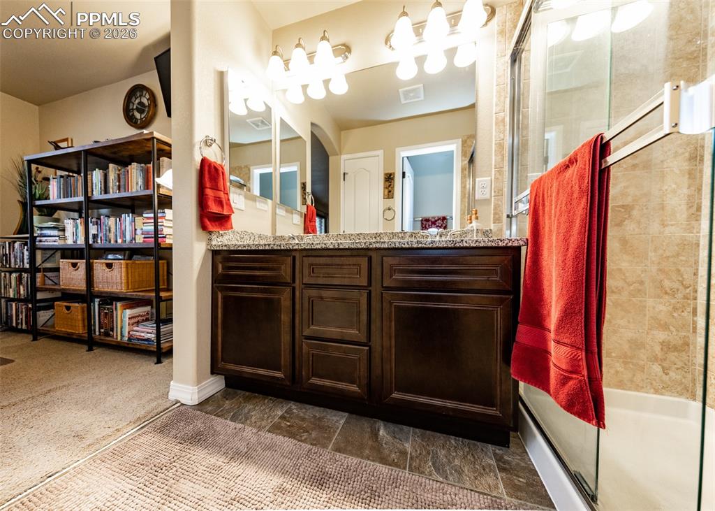 Image 29 of 32: Bathroom with vanity and a shower stall