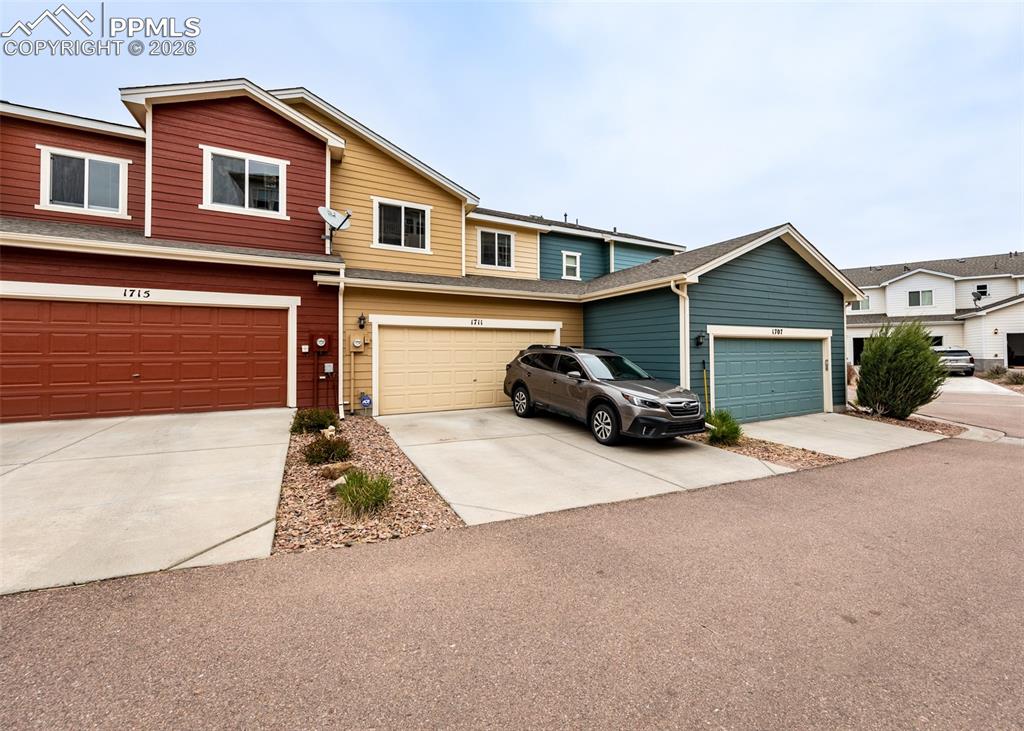 Image 32 of 32: Traditional home with driveway, a garage, and a shingled roof