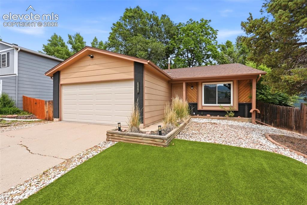 Image 1 of 35: Front exterior featuring horizontal siding, an attached garage, and a cover