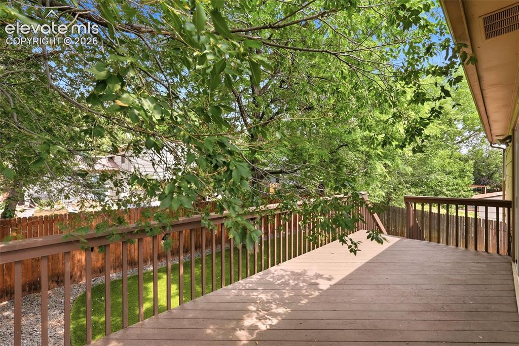 Image 26 of 35: Expansive outdoor deck featuring wood-finish flooring and coordinating wood