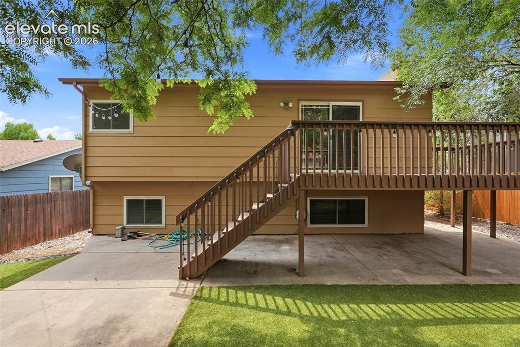 Image 29 of 35: Raised wood deck with full-length handrails and staircase