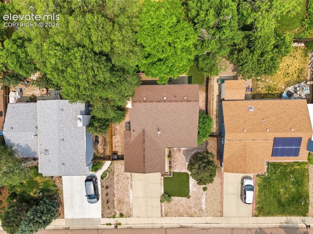 Image 31 of 35: Aerial view of a residential property with a brown shingle roof