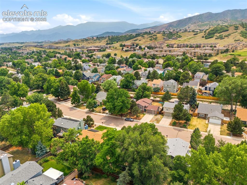 Image 34 of 35: Expansive residential area featuring numerous single-family homes, mature t