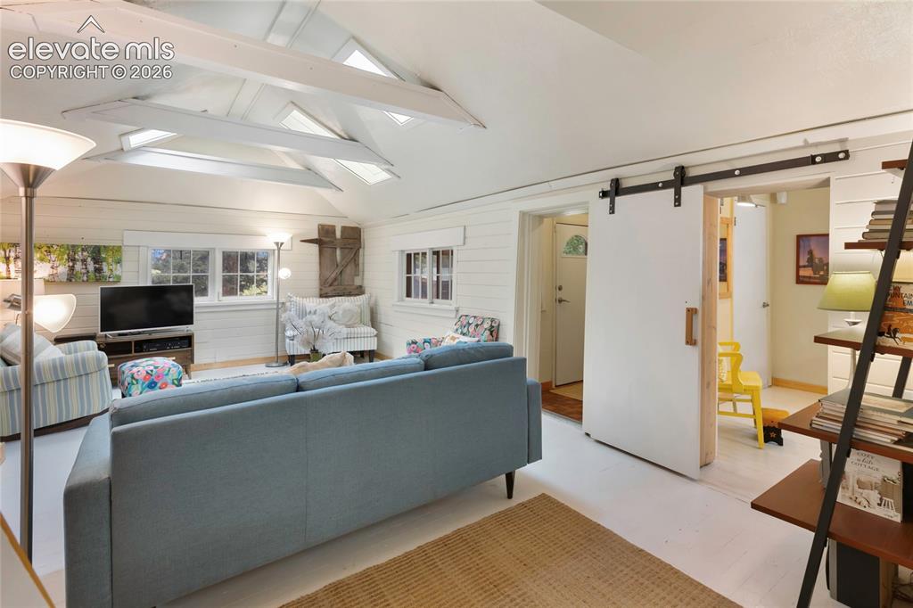 Image 16 of 42: The secondary room off the living room could be a small bedroom, home offic