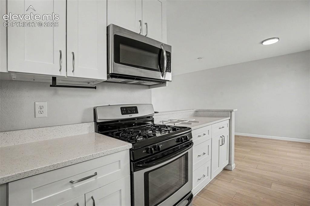 Image 12 of 27: Spacious room featuring light wood-finish flooring, a contemporary ceiling 