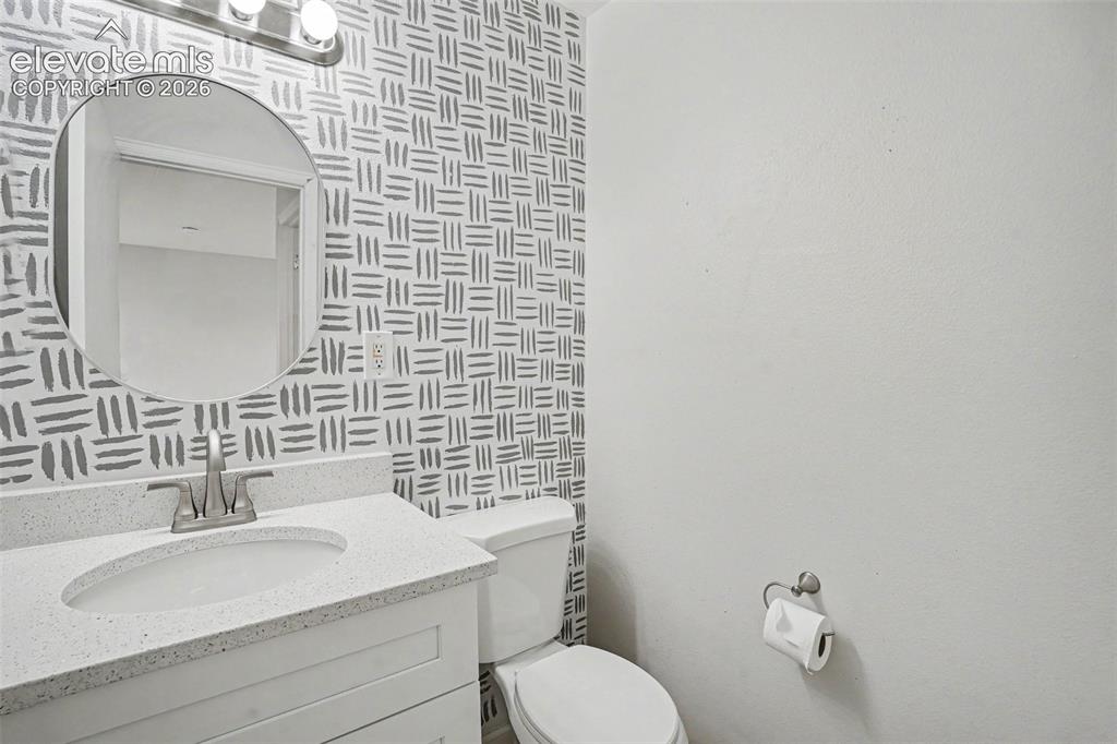 Image 19 of 27: Carpeted room with neutral wall tones and white trim