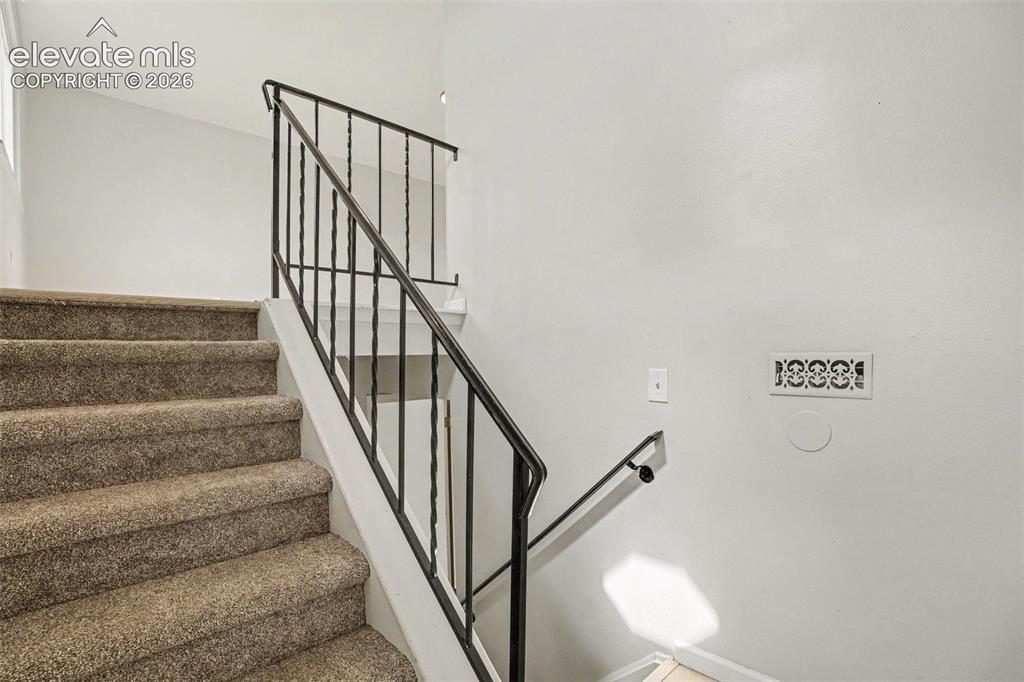 Image 4 of 27: Two-story property featuring gray siding, a circular window, and a single-c