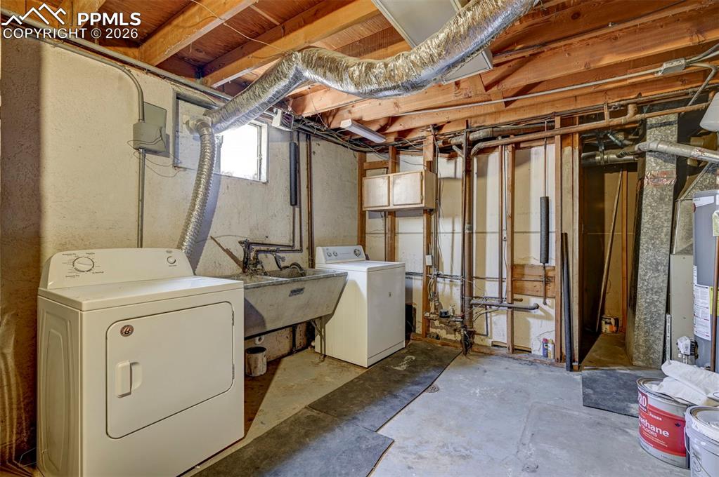 Image 32 of 40: Basement Laundry/Utility Room with Sink.