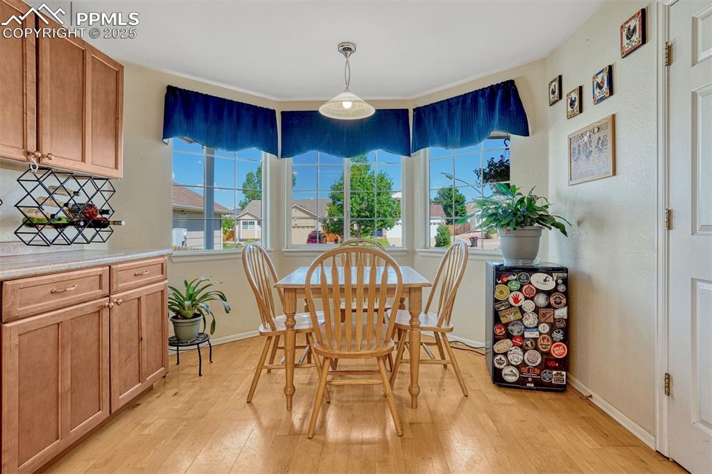 Image 5 of 40: Casual dining in kitchen with large bay picture window 
