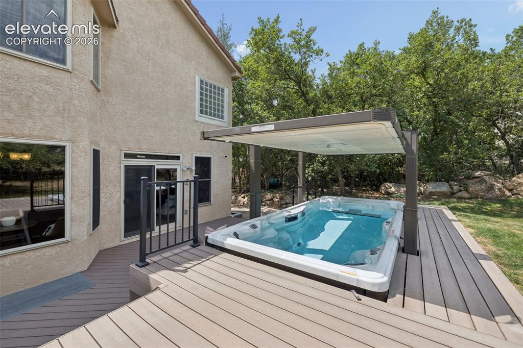 Image 39 of 44: Swim spa with an incredible motorized top that acts as a roof to the swim s