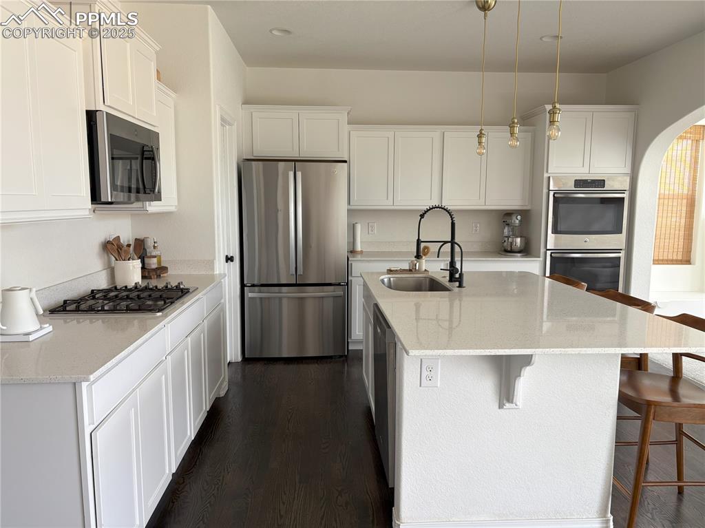 Image 7 of 35: Kitchen featuring stainless steel appliances and real hardwood floors