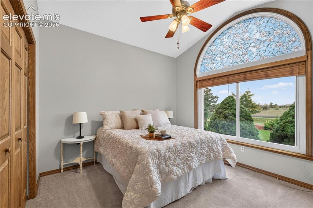 Image 20 of 44: Vaulted ceiling featuring a ceiling fan with light fixture, decorative arch