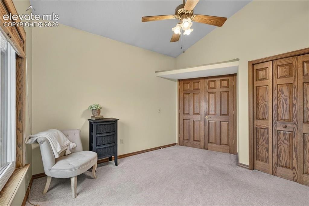 Image 24 of 44: Vaulted ceiling with a central multi-blade light fixture, natural wood-fini