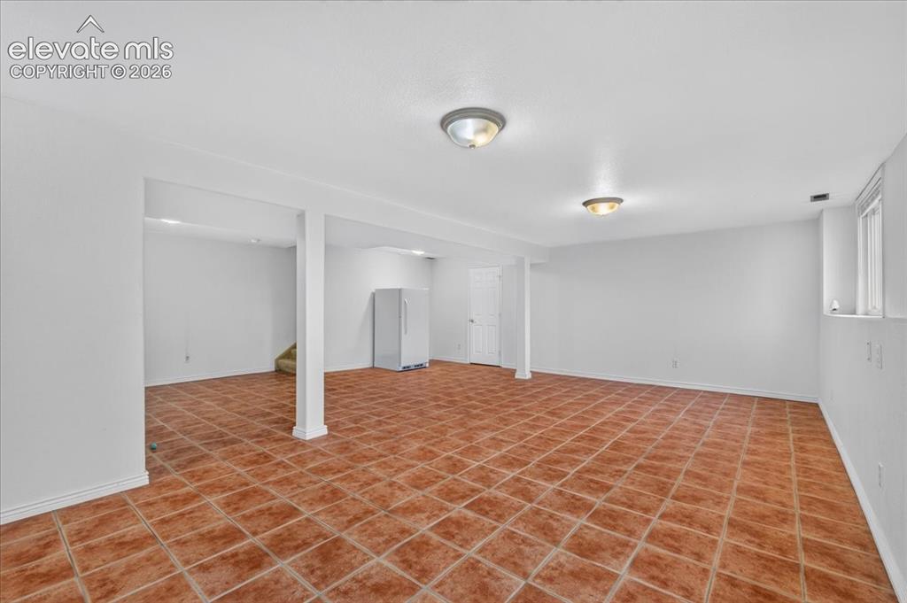 Image 26 of 44: Open-concept interior featuring ceramic tile flooring, neutral walls, struc