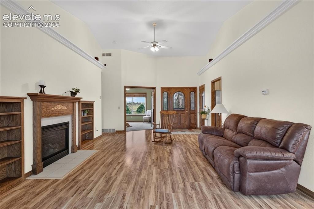Image 5 of 44: Vaulted ceilings featuring a central light fixture, wood-finish flooring, f