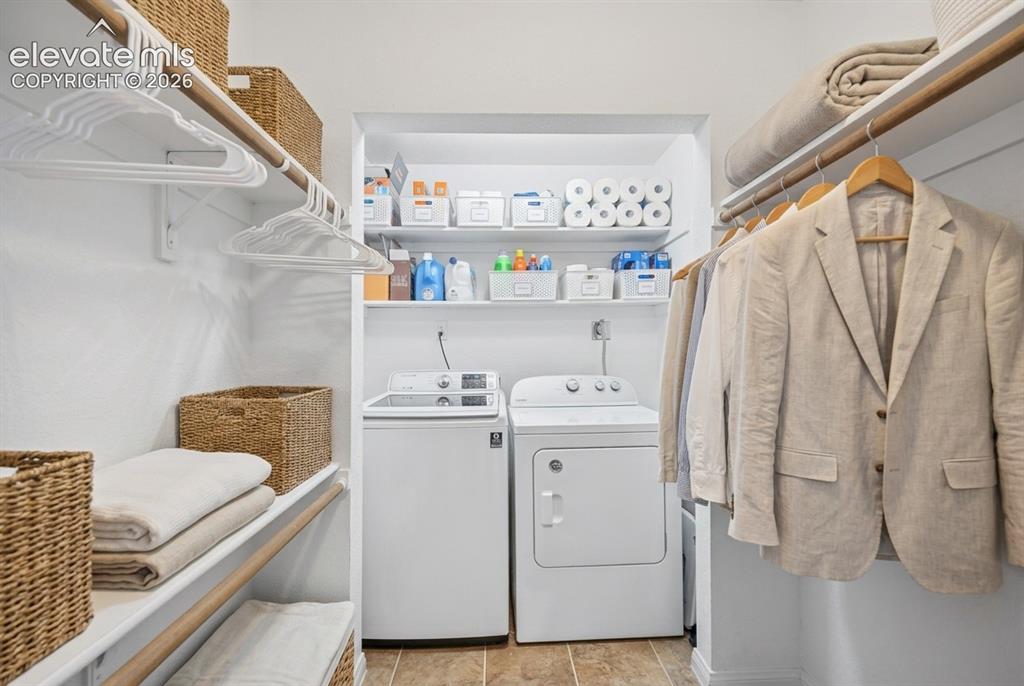 Image 10 of 20: Laundry area with full-size washer and dryer, adjacent to closet storage