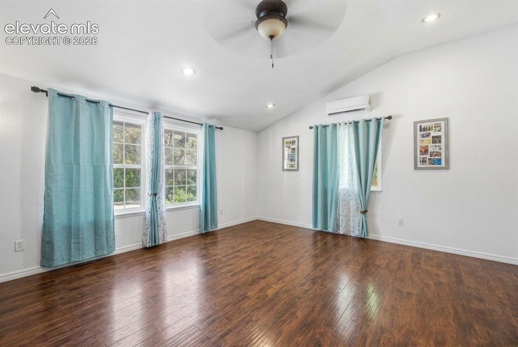 Image 2 of 20: Vaulted ceiling with a ceiling fan, wood-finish flooring, recessed lighting
