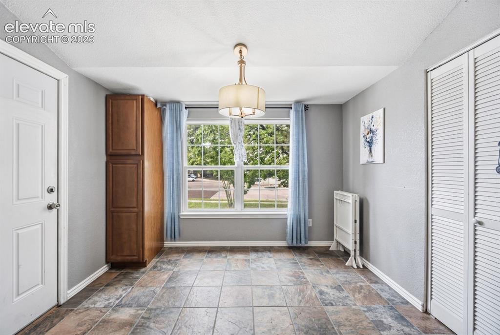 Image 5 of 20: Tiled flooring throughout, featuring a large window with natural light, a b