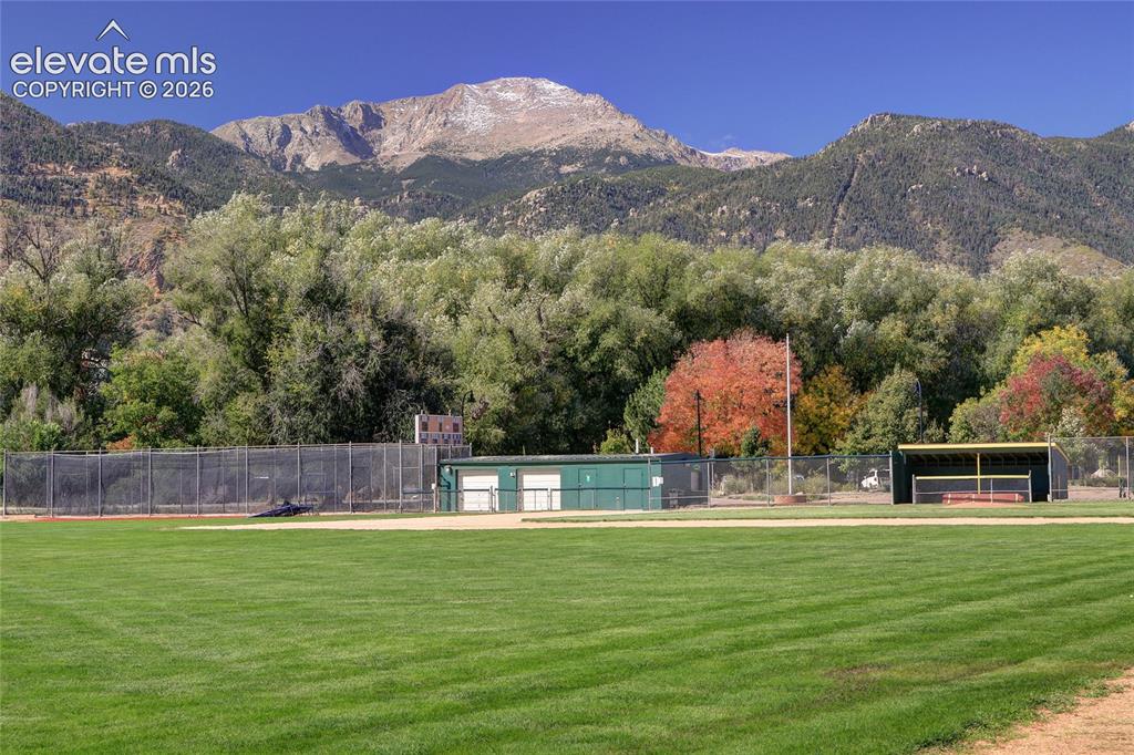 Image 25 of 26: Expansive grounds featuring a manicured grass field, ball diamond, chain-li