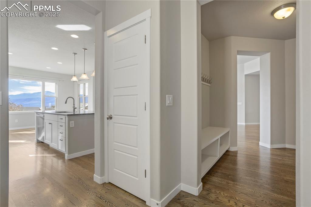 Image 16 of 50: Hallway with dark wood finished floors, a mountain view, and recessed light