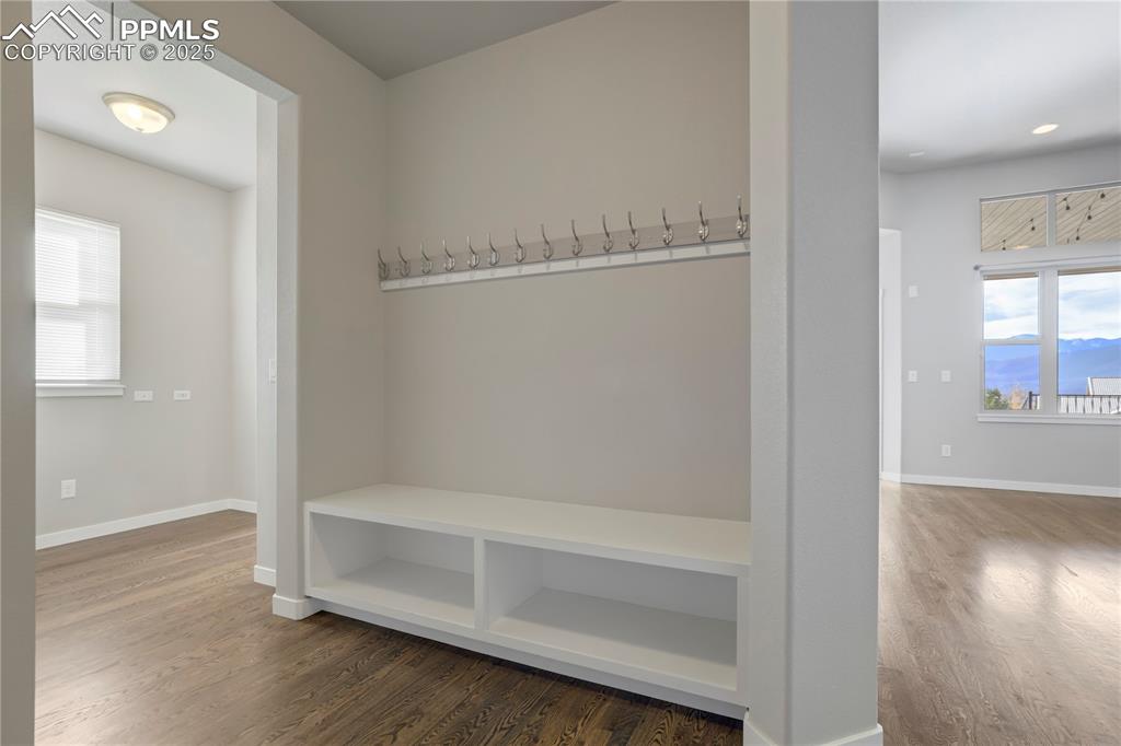 Image 17 of 50: Mudroom with plenty of natural light, wood finished floors, and a mountain 