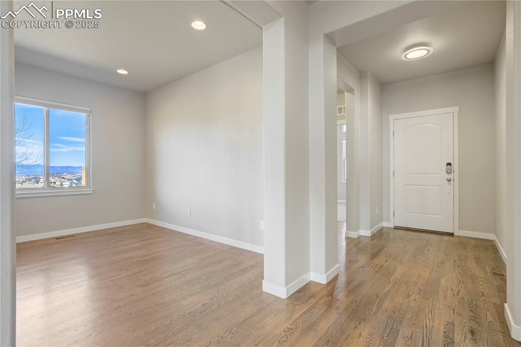 Image 27 of 50: Foyer with light wood-style floors, recessed lighting, and a mountain view