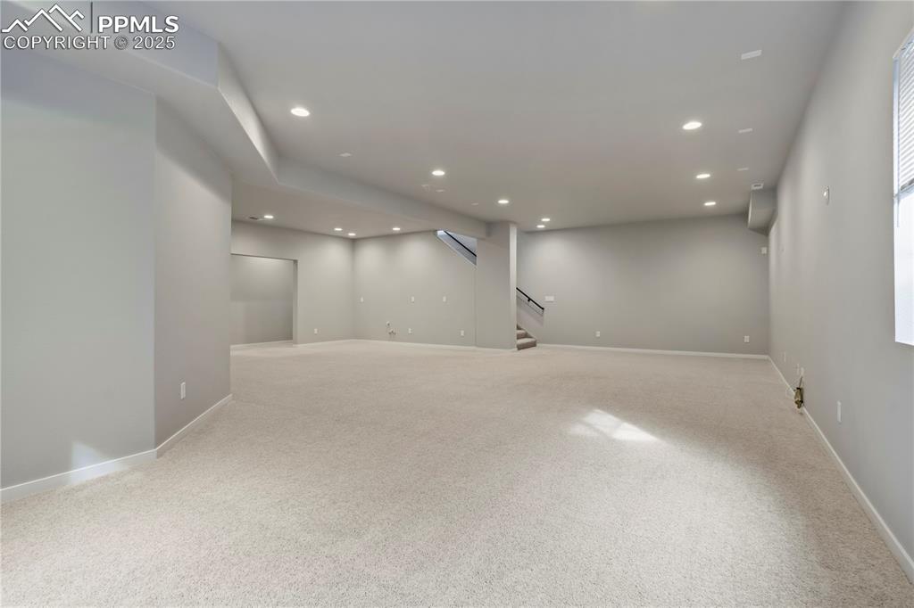 Image 35 of 50: Basement featuring recessed lighting, light carpet, and stairs