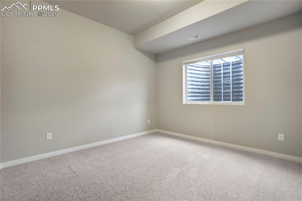 Image 37 of 50: Carpeted spare room with baseboards