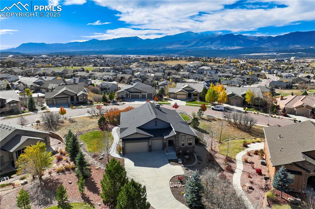 Image 4 of 50: Aerial perspective of suburban area with a mountain backdrop