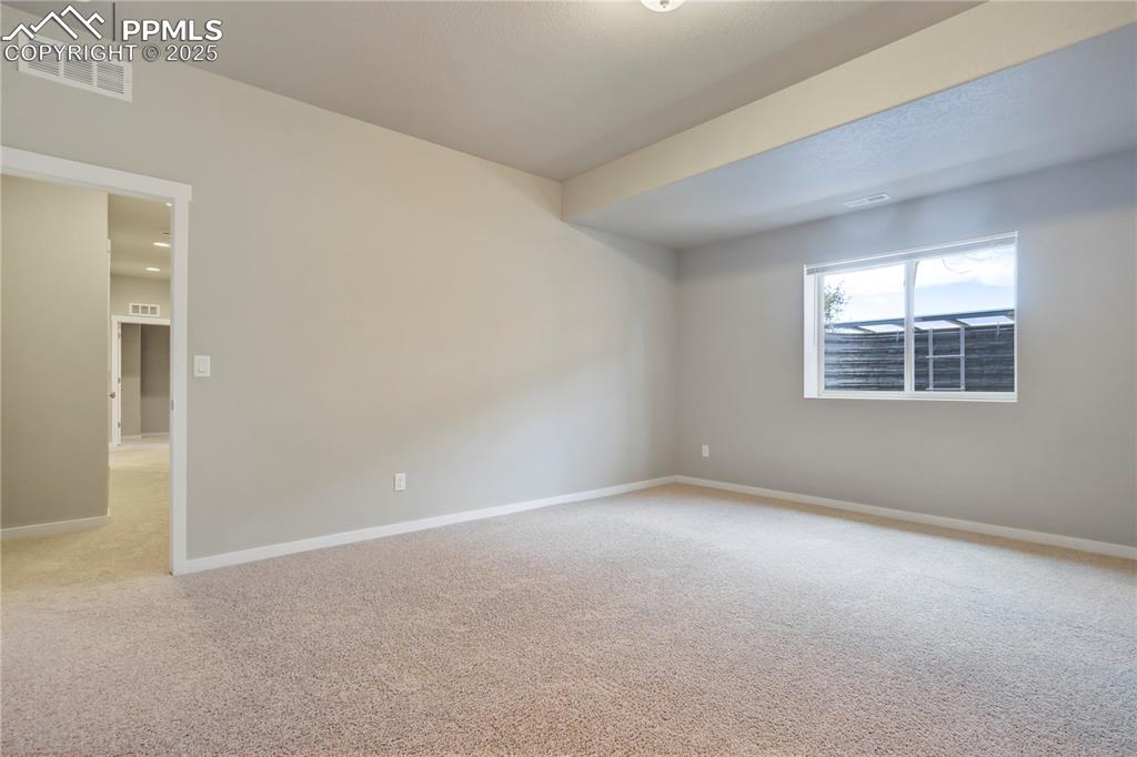 Image 41 of 50: Carpeted room with baseboards