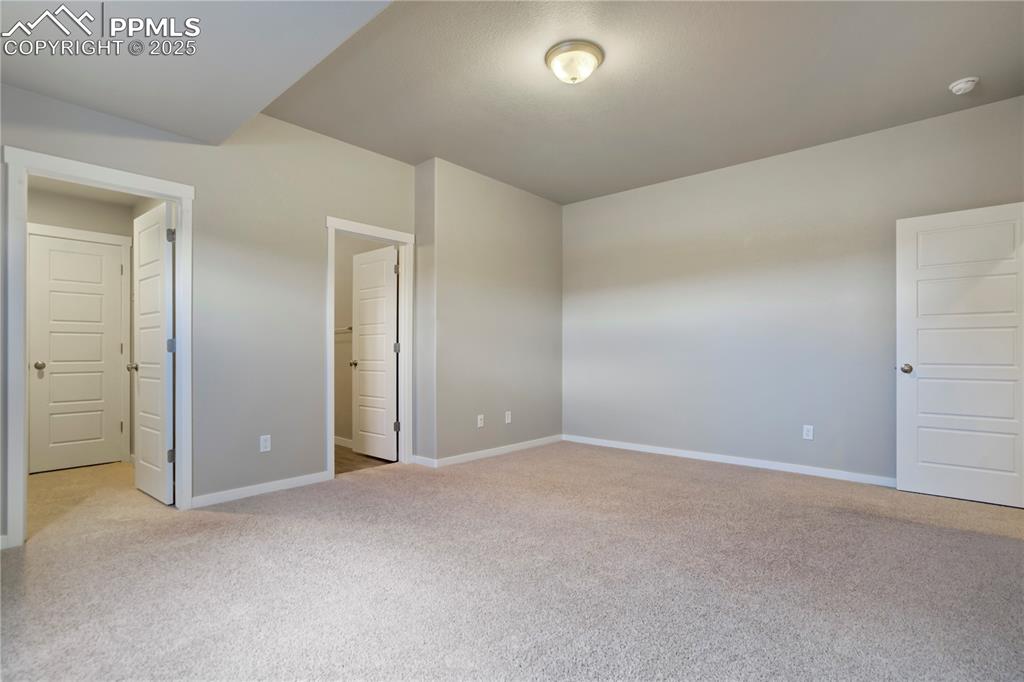 Image 42 of 50: Bedroom featuring light carpet and baseboards