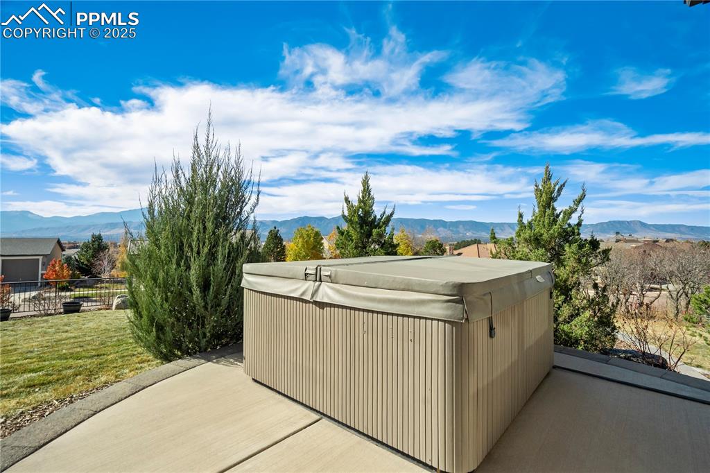 Image 48 of 50: View of patio featuring a mountain view and a hot tub