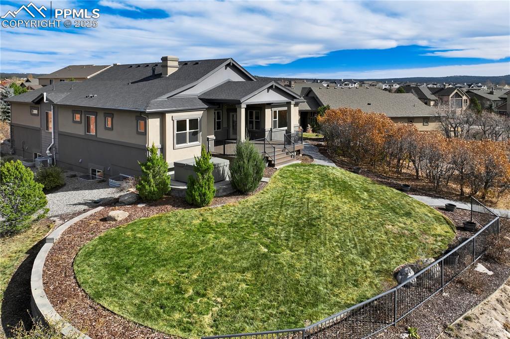 Image 50 of 50: View of the rear of house featuring a deck, a shingled roof, and stucco sid