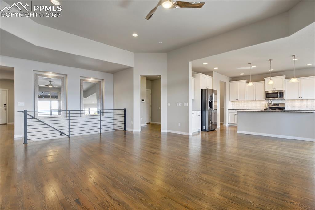 Image 7 of 50: living room featuring ceiling fan, recessed lighting, and dark wood-type fl