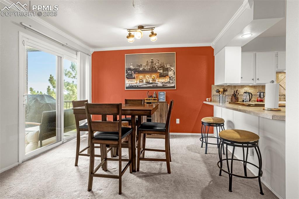Image 18 of 37: Dining area, opens to the new composite deck and mountain views.