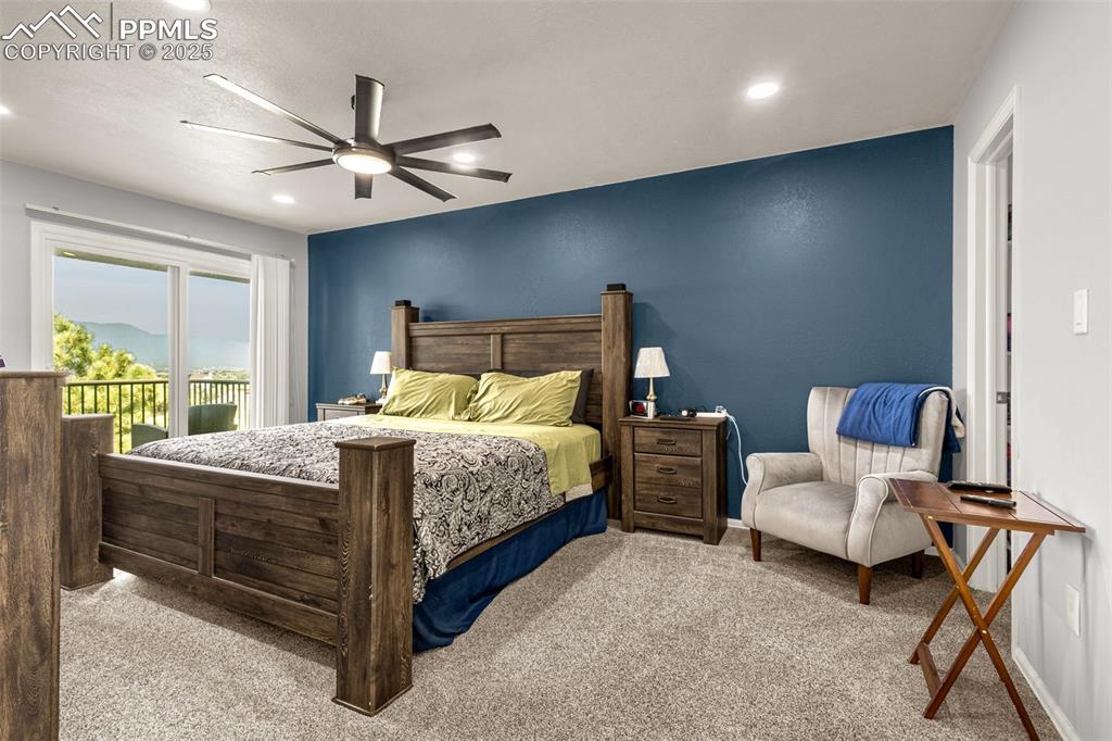 Image 27 of 37: Primary bedroom with private deck, mountian and open space views.