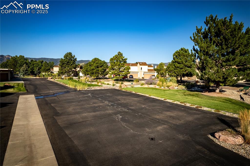 Image 36 of 37: Visitor parking next to the beautiful center green space
