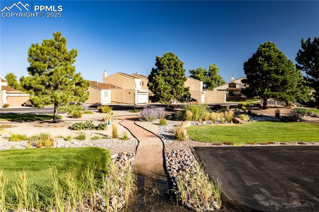 Image 7 of 37: Visitor parking next to the beautiful center green space