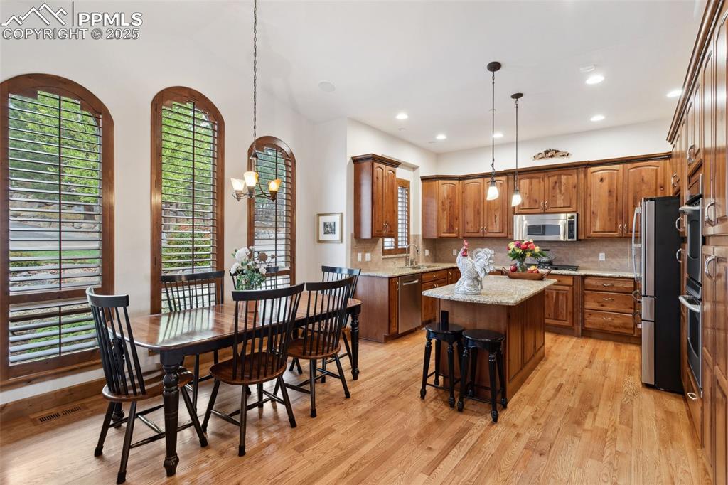 Image 10 of 49: The Island Kitchen offers hard wood floors, arched windows with plantation
