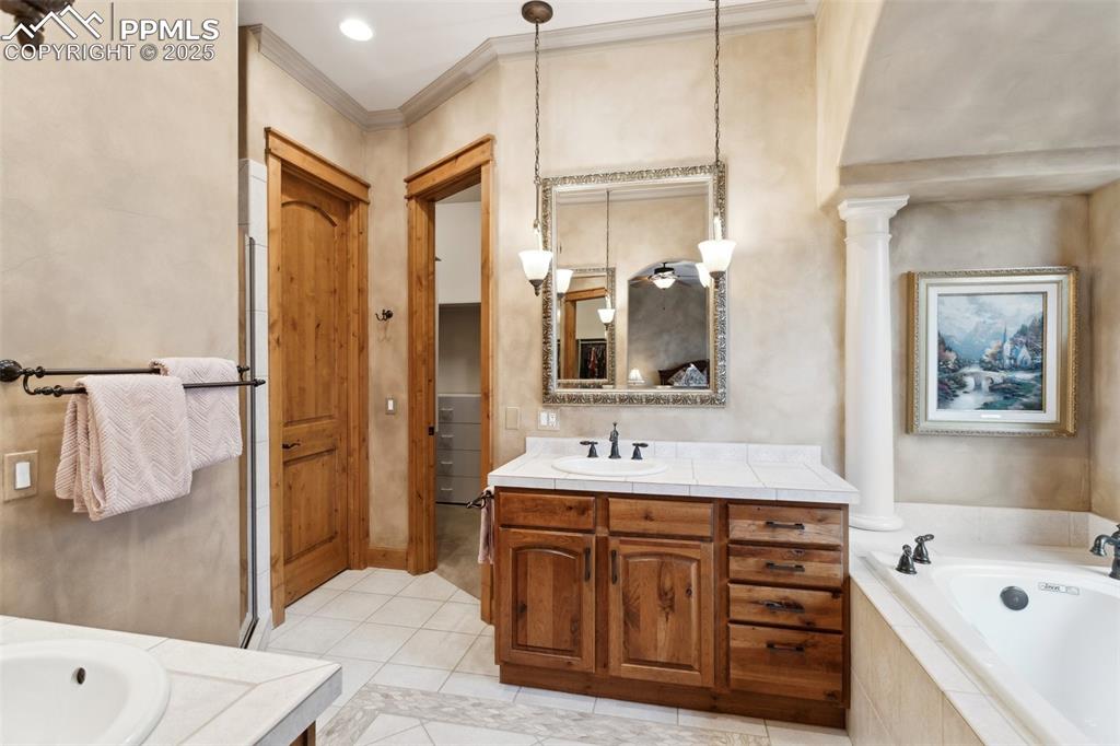 Image 21 of 49: The Primary Bathroom has a tile floor, dual vanities, framed mirrors, a soa