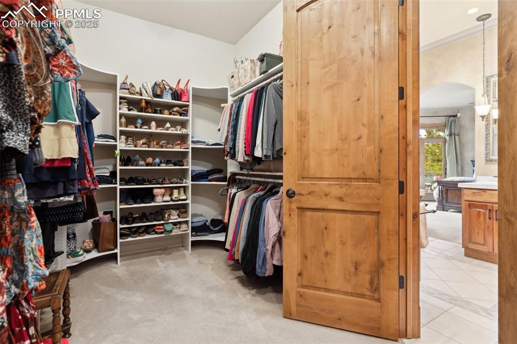 Image 25 of 49: Spacious walk in closet with custom organizer in the main level Primary Bed
